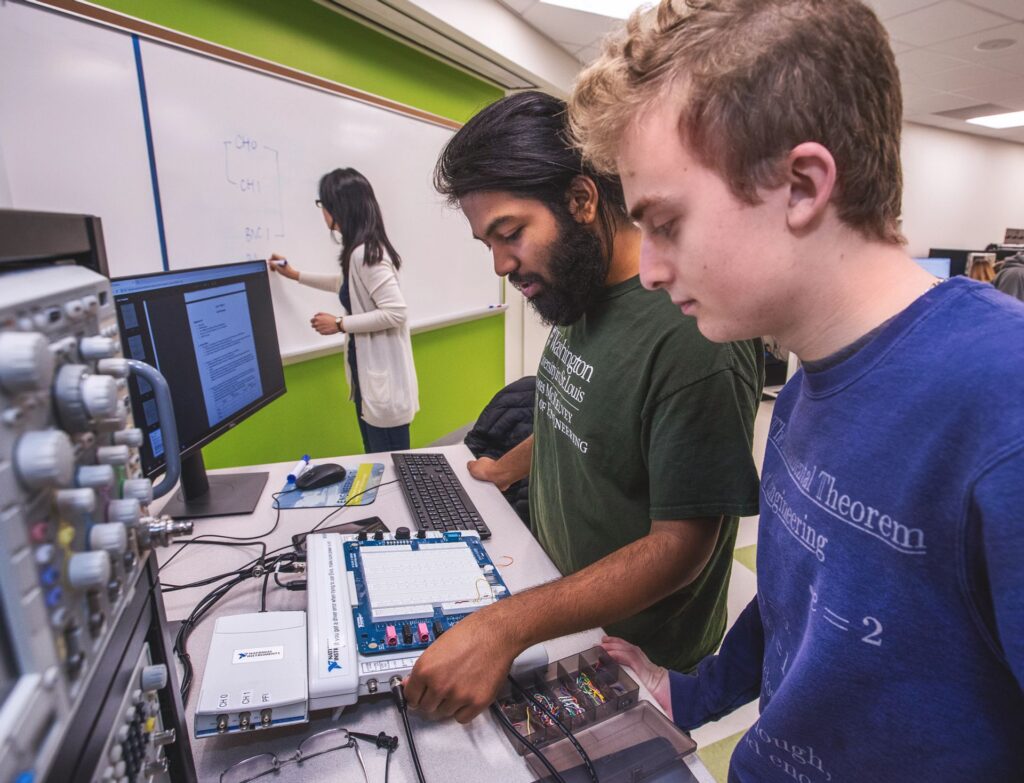 Two students discuss a project during class